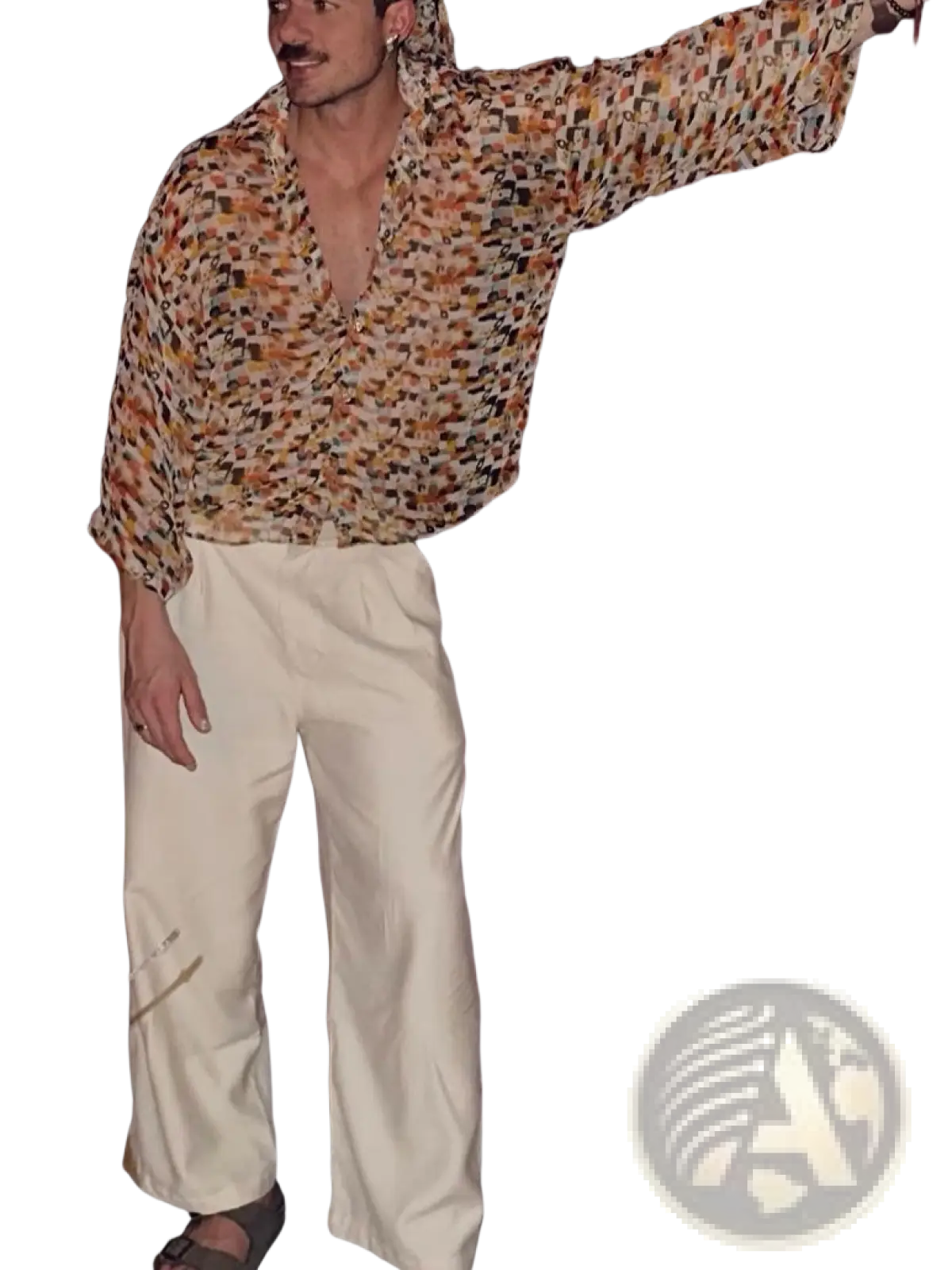 A man wearing a retro geometric sheer oversized vacation shirt with an earthy-toned geometric pattern in brown and beige