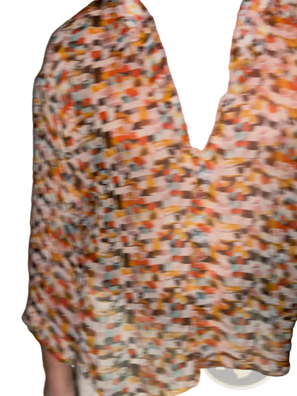 A vibrant retro geometric sheer oversized vacation shirt with short sleeves in orange brown and teal on a light background