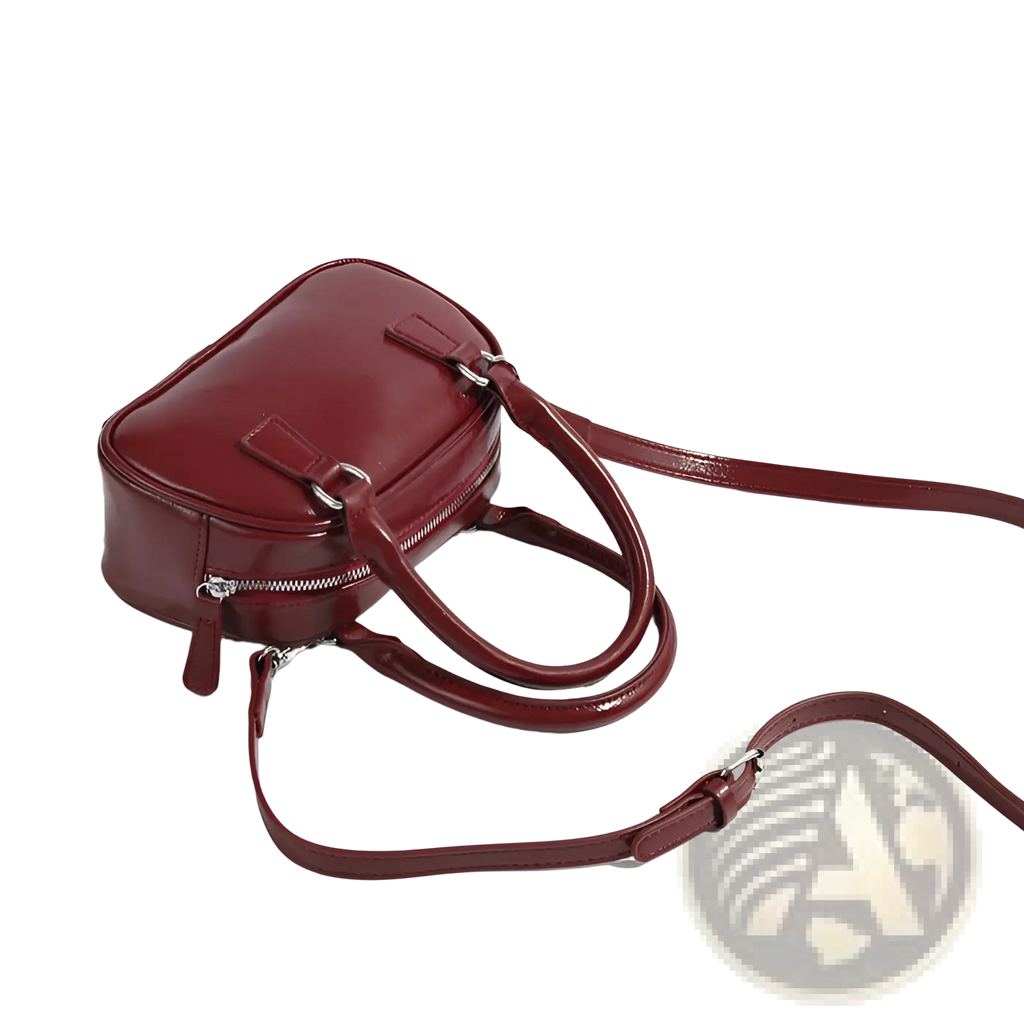 A retro glossy pu leather small square handbag in burgundy with dual top handles and an adjustable shoulder strap