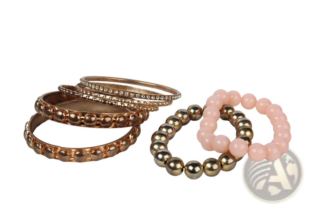 A set of rose gold-toned rhinestone and beaded bangles with a pink and metallic bead bracelet in retro style