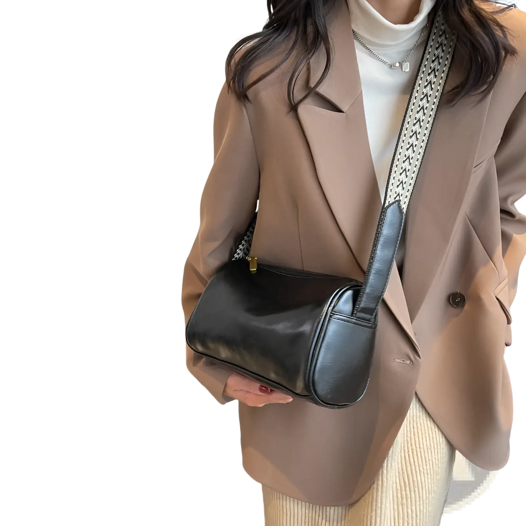 Black leather retro crossbody bag with a patterned strap designed for stylish everyday use