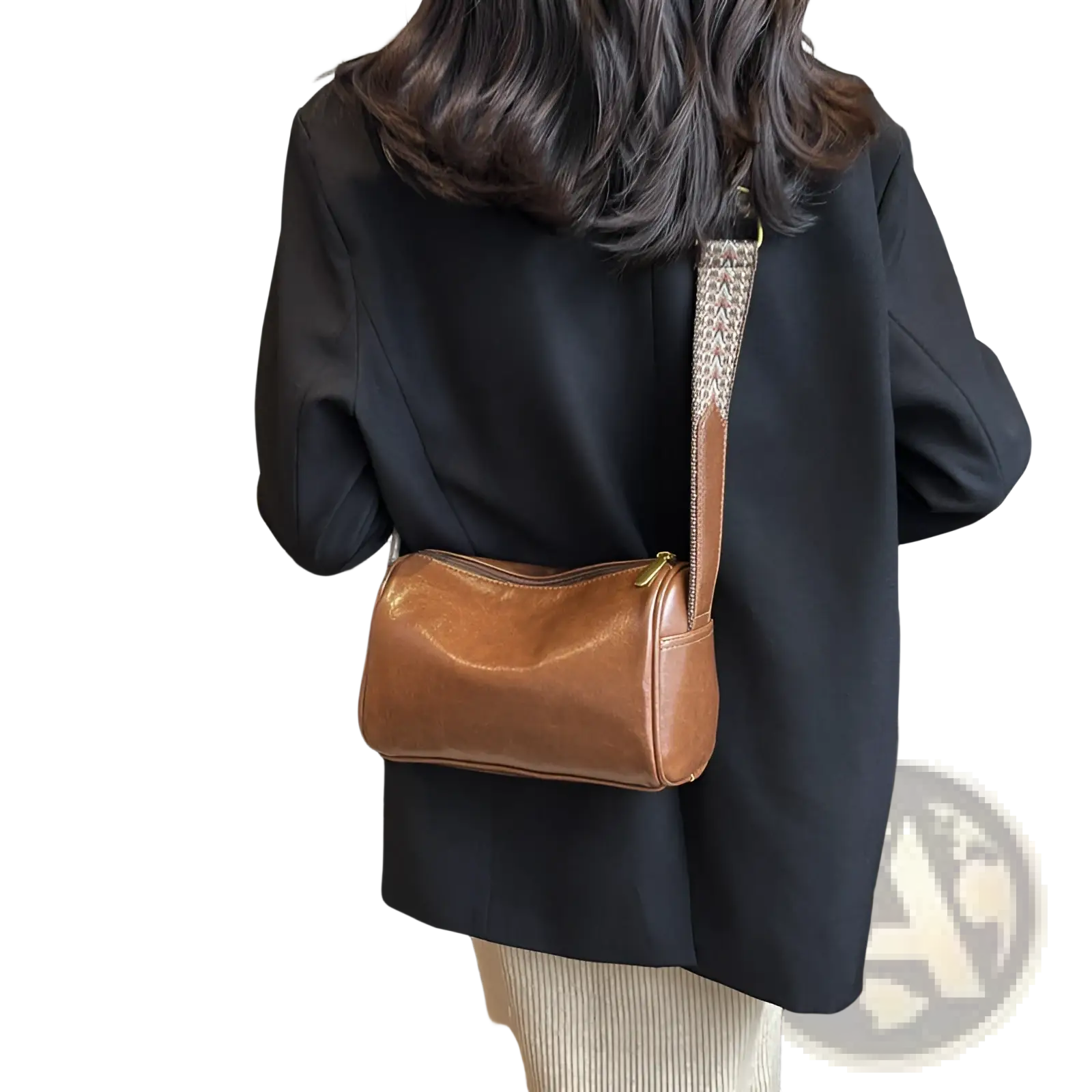 Retro leather crossbody bag featuring brown leather and a patterned strap with a gold-tone zipper closure