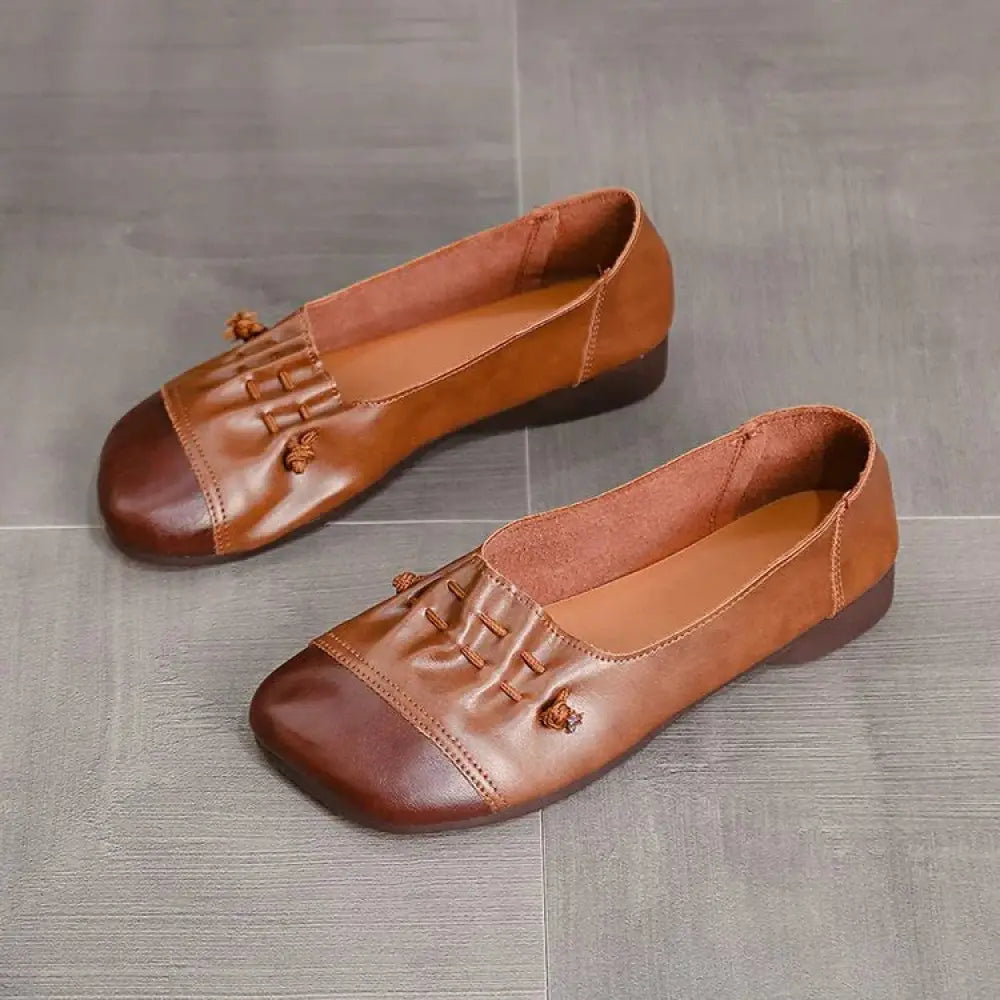 Brown leather retro soft sole loafers with darker toe cap and braided tassels on the vamp