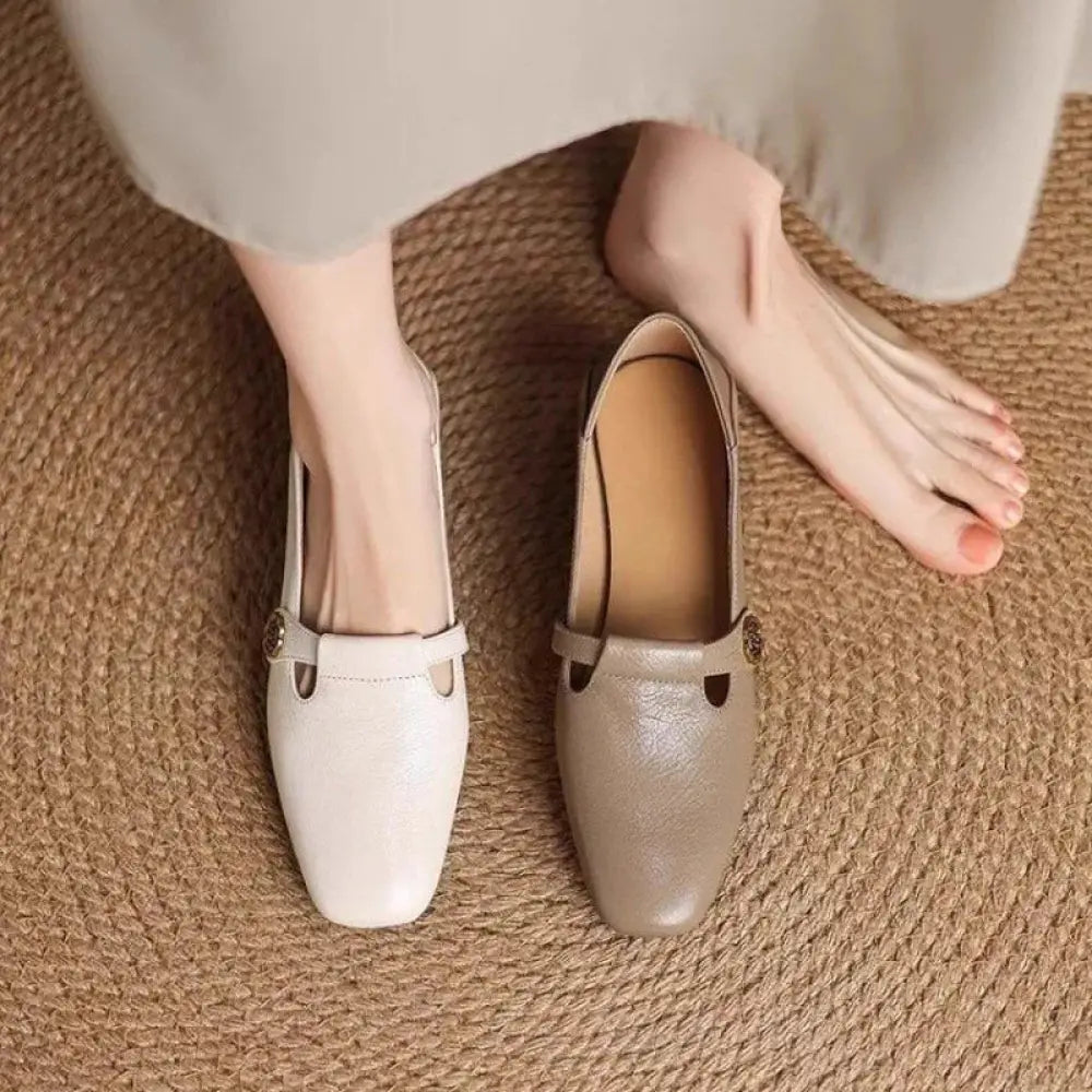 A pair of retro square toe leather loafers in cream and taupe with rose buckle detail