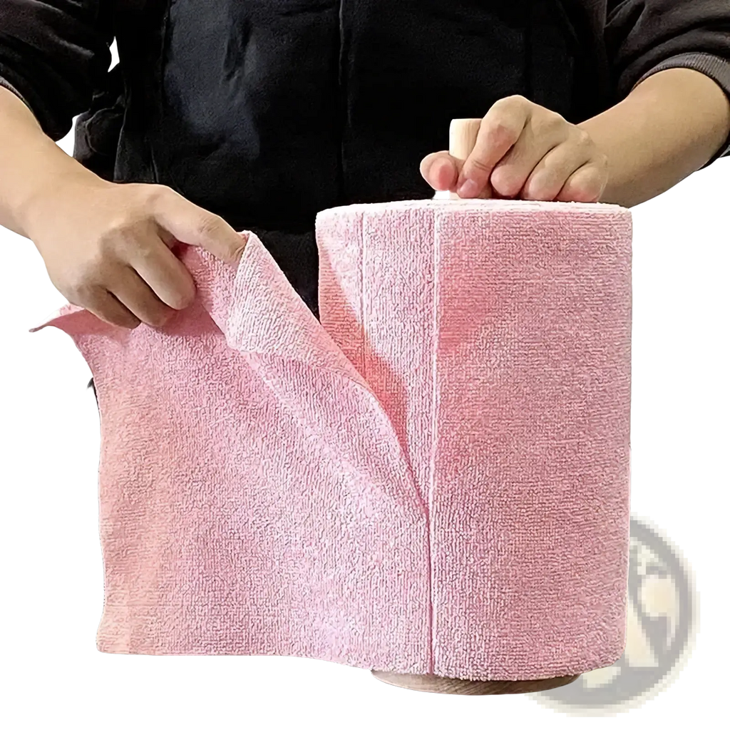Pink reusable microfiber kitchen towel roll made of soft microfiber fabric wrapped around a wooden cylinder