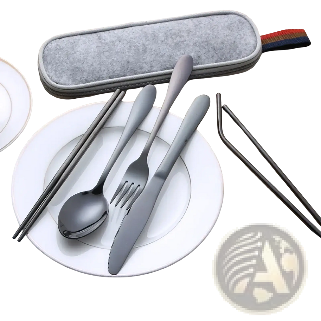 Gray stainless steel reusable travel cutlery set with flatware chopsticks and straws neatly arranged on white plate