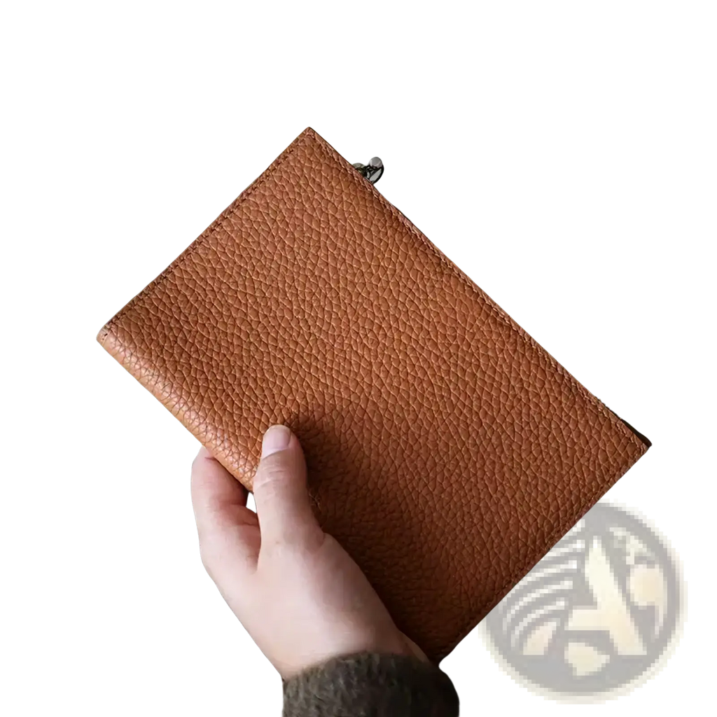 A tan pebbled leather rfid passport holder travel wallet with a silver zipper pull for secure travel