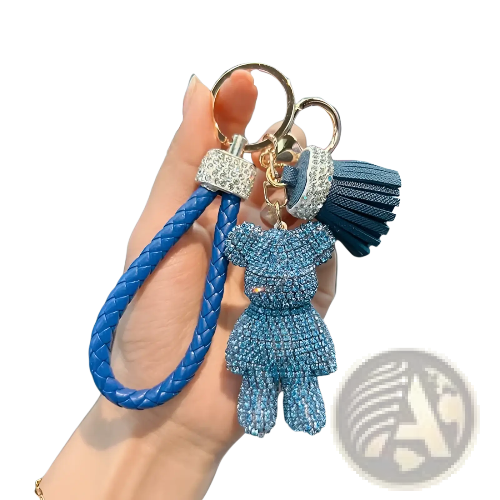 A blue braided leather keychain with a rhinestone-adorned teddy bear charm and matching tassel
