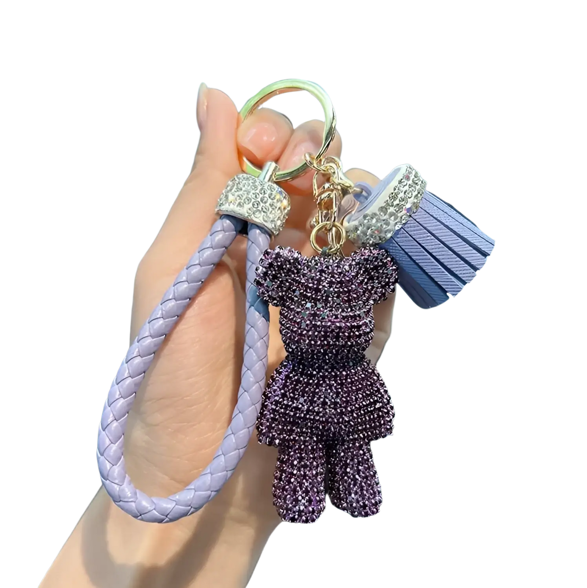 A lavender braided leather rhinestone bear keychain with purple charm tassel and crystal metal accents