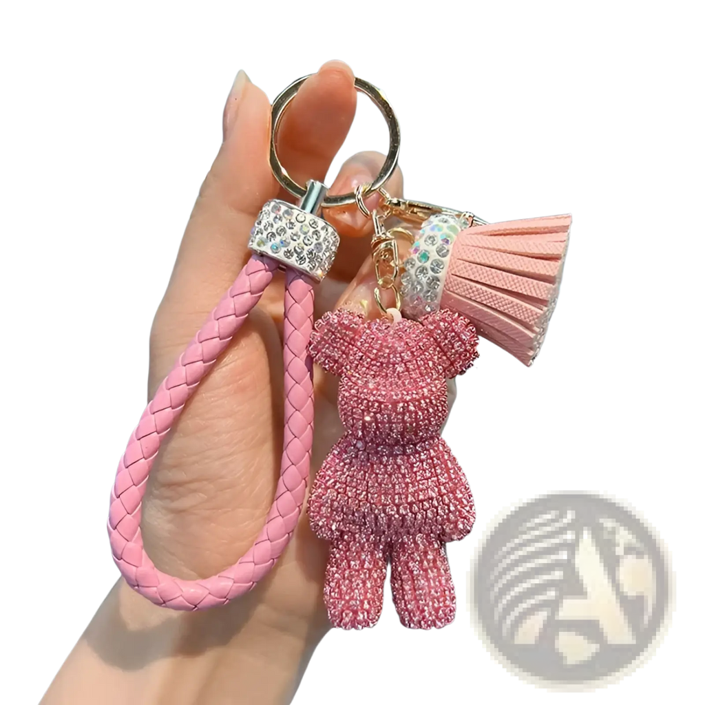 Pink braided leather keychain with rhinestone bear charm and matching tassel for stylish accessory use