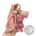 Pink braided leather keychain with rhinestone bear charm and matching tassel for stylish accessory use