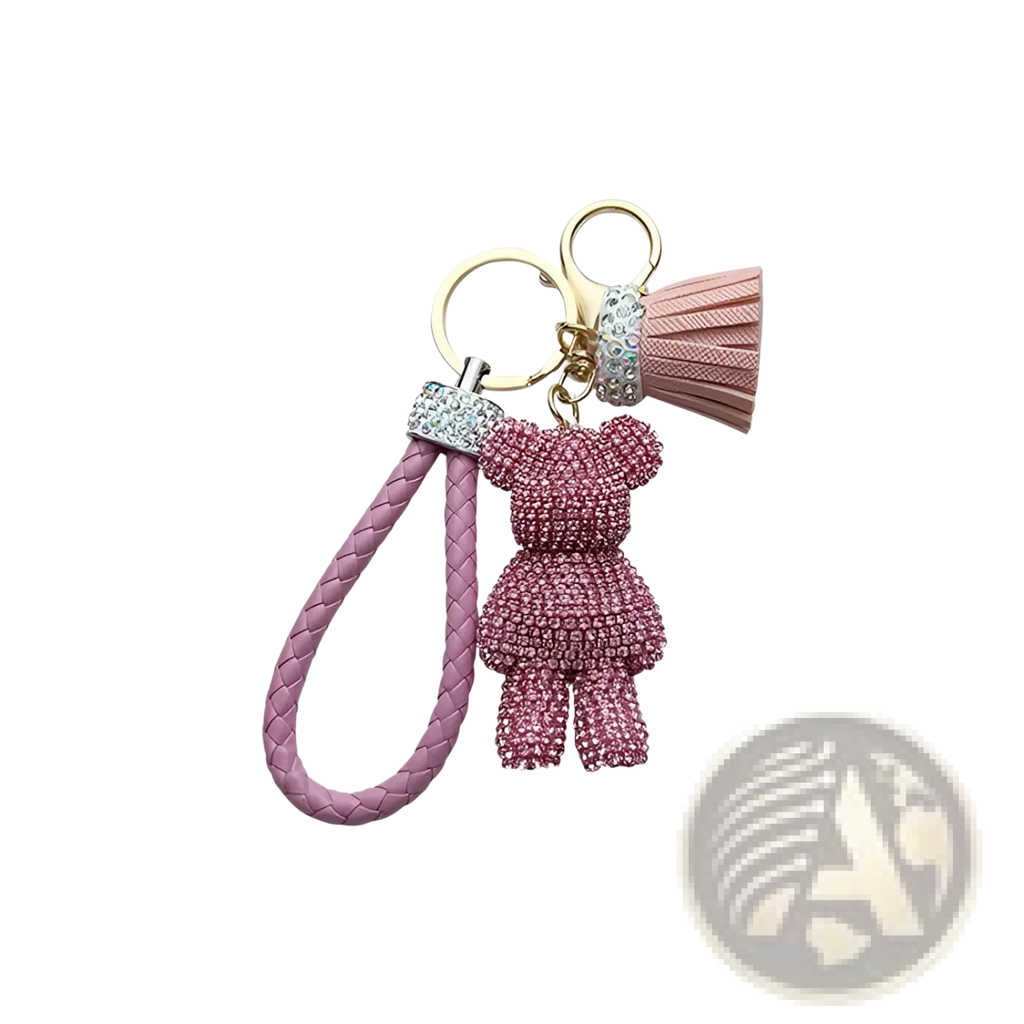 Pink rhinestone-encrusted bear keychain with braided leather strap and tassel for stylish accessory use