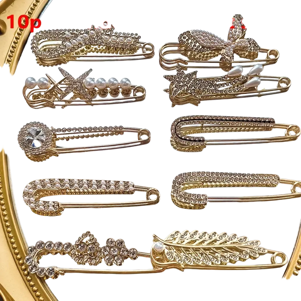 Gold-toned rhinestone brooch pin set with safety pin hair clips adorned with pearls bows stars flowers and feathers