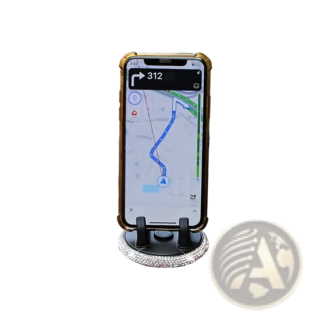 A gold-framed smartphone mounted in a black rhinestone car phone holder vent mount displaying navigation