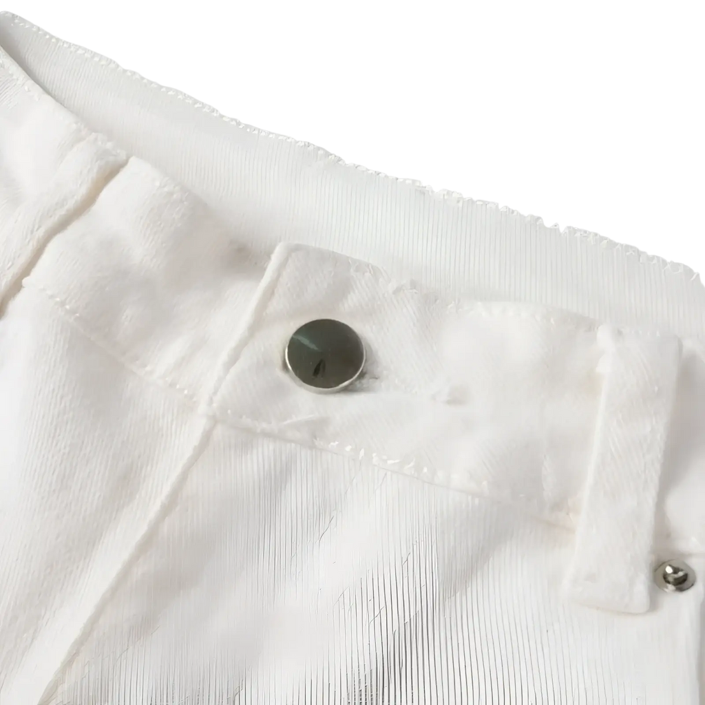 A sleek silver metal button on white denim fabric of rhinestone distressed white mens slim fit jeans