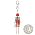 A red and silver rhinestone-encrusted woman-shaped keychain with a glossy red bead head and glittery purse pendant