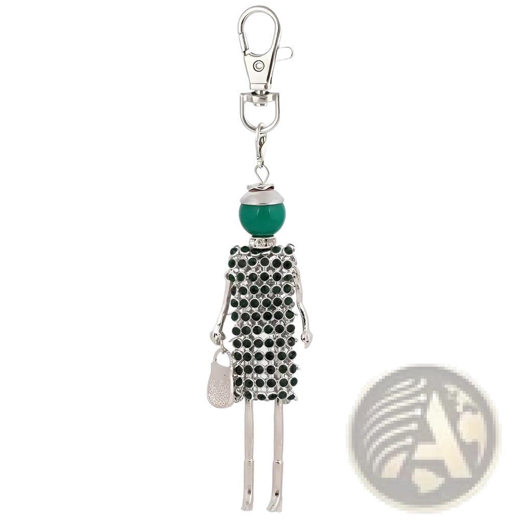 Silver-toned rhinestone doll keychain featuring a stylized female figure with green bead head and black dress holding handbag