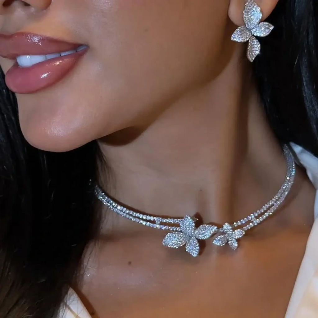 A sparkling silver rhinestone choker necklace with diamond-encrusted butterfly charms from the bridal jewelry set