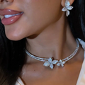 A sparkling silver rhinestone choker necklace with diamond-encrusted butterfly charms from the bridal jewelry set