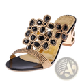 Black and gold rhinestone high heel sandals featuring floral design with large black stones and metallic gold accents