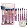 Set of ten rhinestone makeup brushes with pink glittery and silver handles in a rose gold textured case