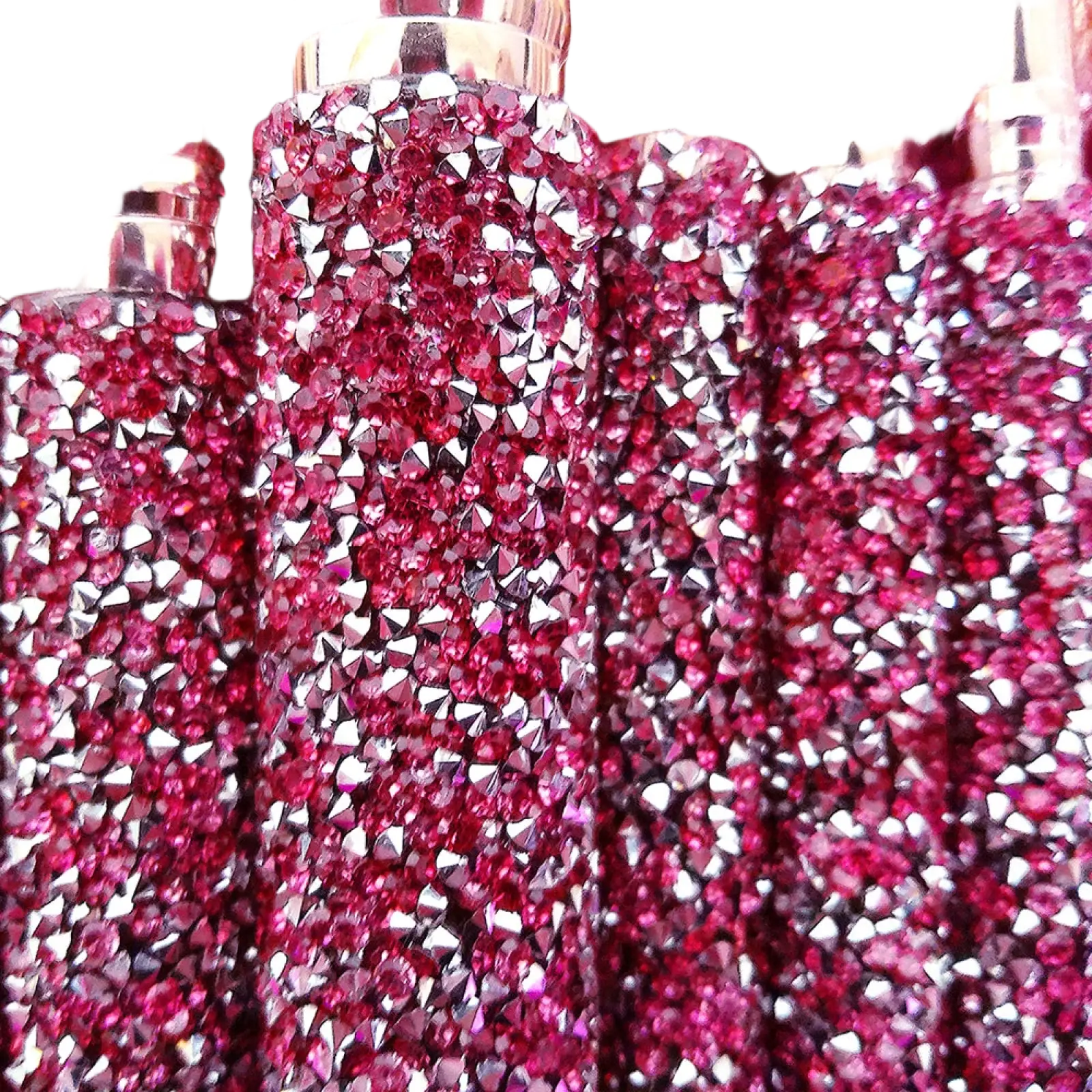 A sparkling pink rhinestone-encrusted perfume bottle with a metallic cap from a rhinestone makeup brush set 10 piece pink
