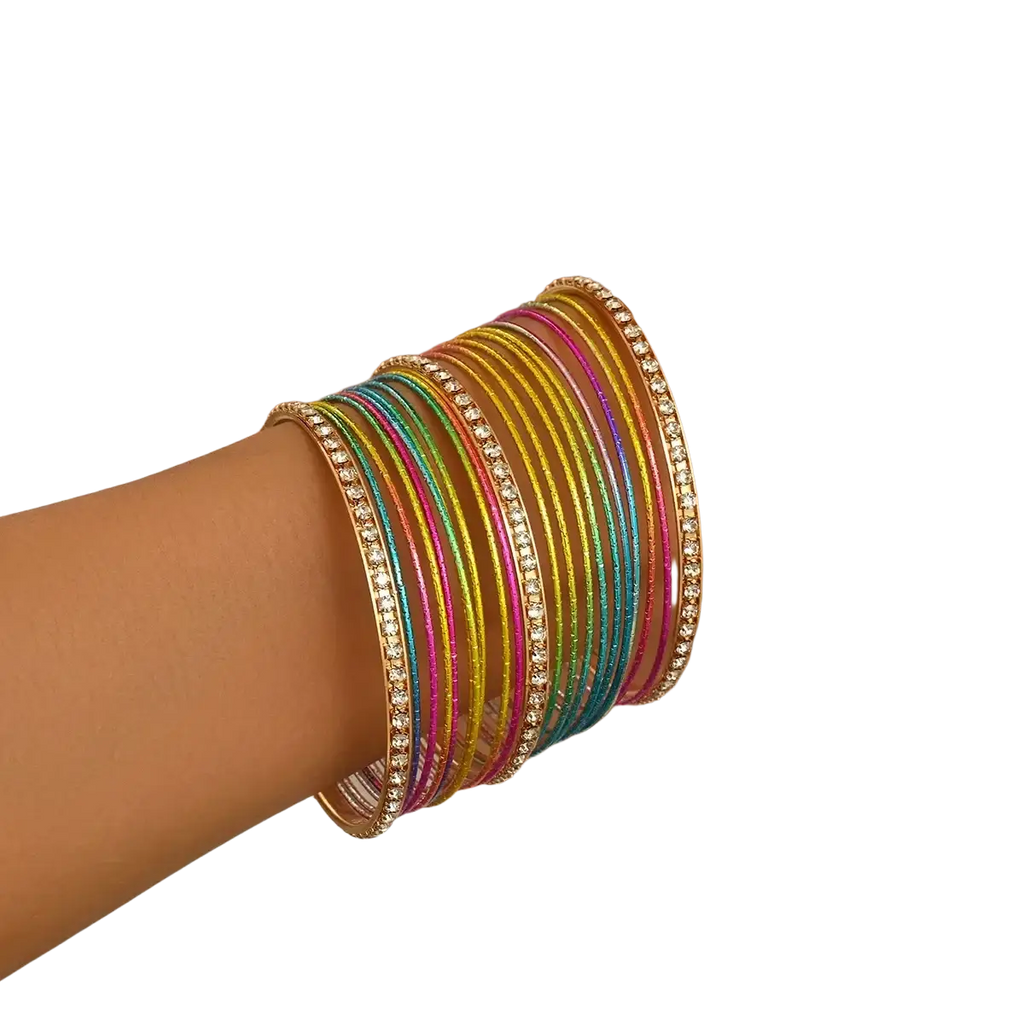 A stack of colorful glittery rhinestone metal bangles worn on a wrist in a rhinestone metal bangle set for women
