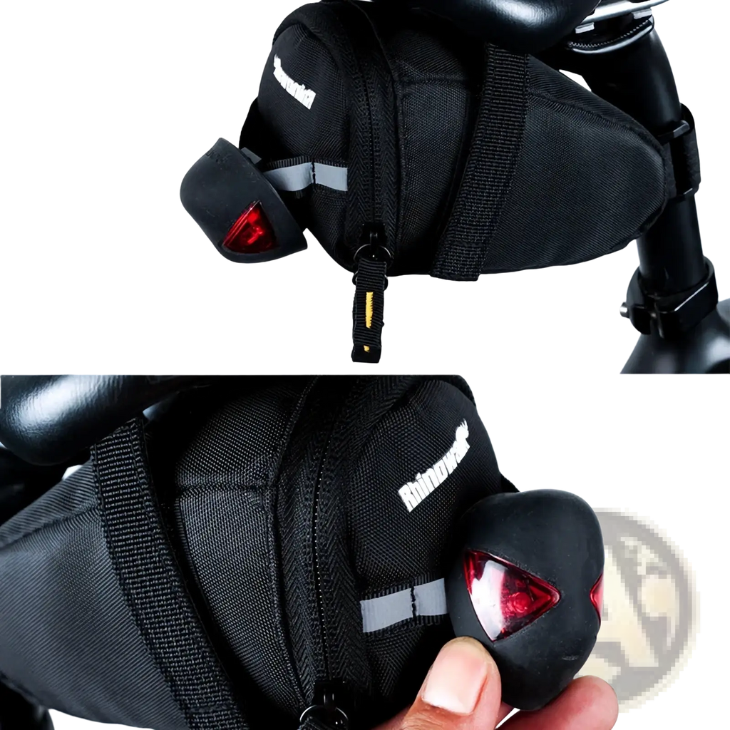 Back side of black rhinowalk waterproof bike saddle bag with red led tail light attached for cycling safety