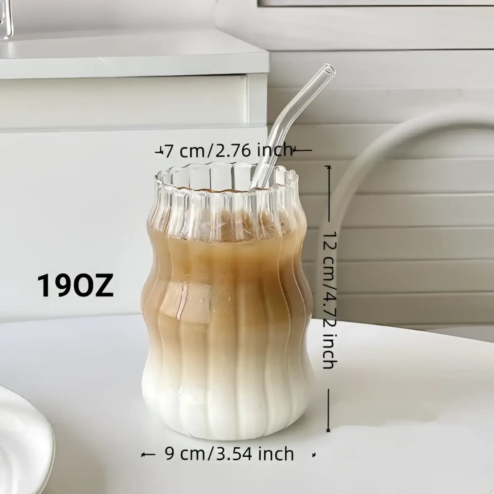 A clear 19oz ribbed glass tumbler with fluted wavy design and matching curved straw from a 6 piece set