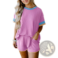 Pink ribbed knit two-piece lounge set with blue and beige contrast trim on neckline sleeves and hem