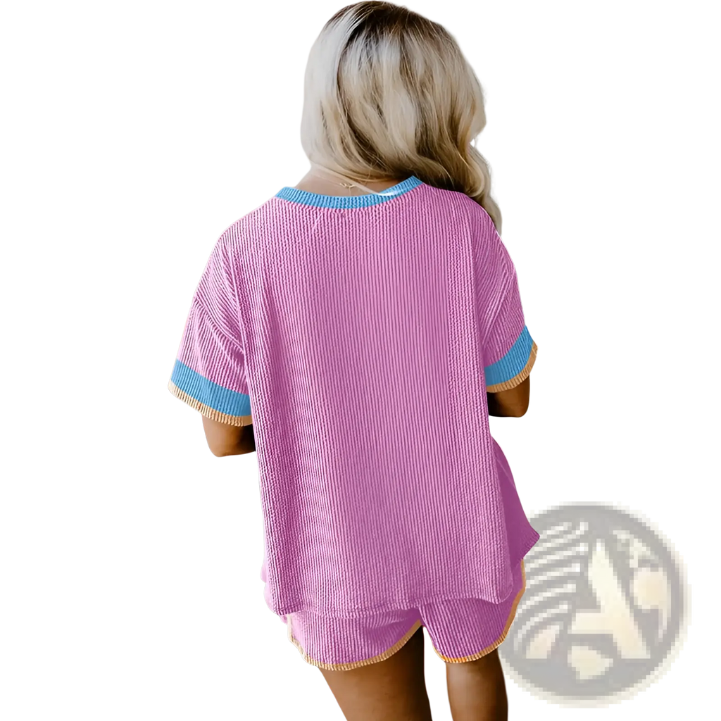 Pink ribbed knit two-piece pajama set with blue and yellow contrast trim for comfortable lounging