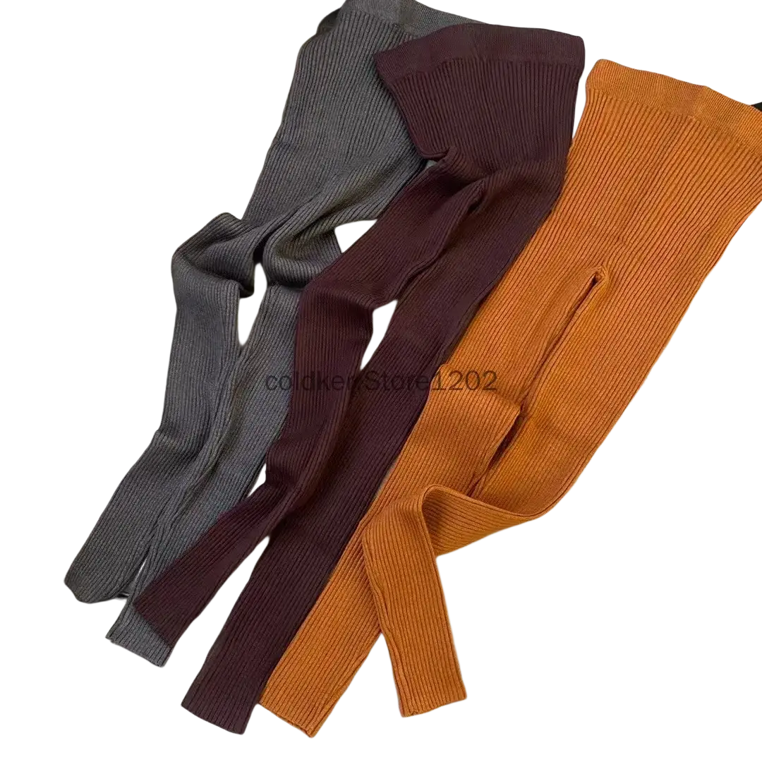 Three ribbed knit leggings high waist winter pants in gray burgundy and orange laid out on a light-colored couch