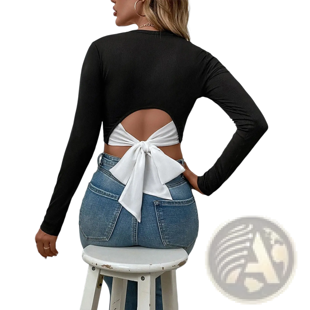 Back view of a black ribbed long sleeve crop top with a white satin bow tied at the back