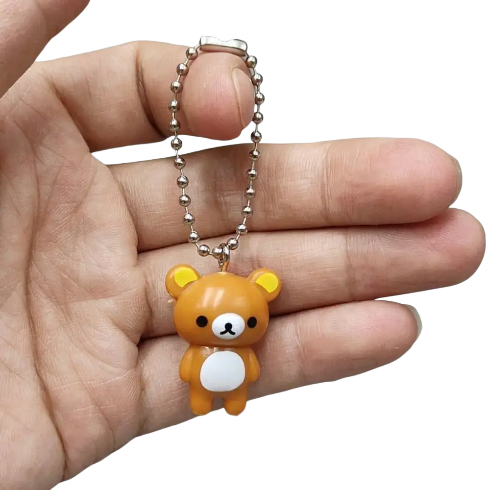 A small orange rilakkuma bear keychain charm with white belly and silver ball chain for cute diy pendant use