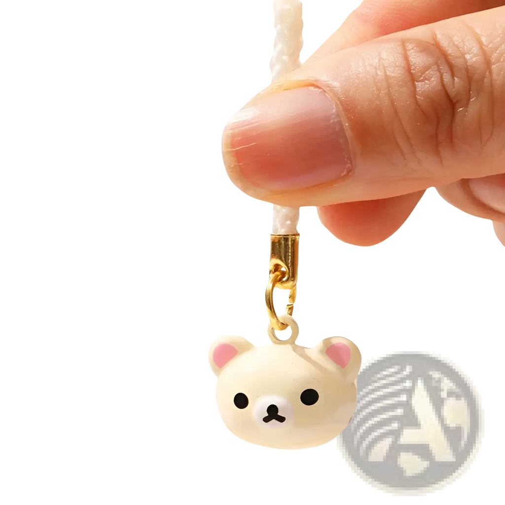 Cute cream-colored rilakkuma bear keychain charm with pink inner ears black eyes and gold-toned clasp in enamel set