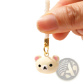 Cute cream-colored rilakkuma bear keychain charm with pink inner ears black eyes and gold-toned clasp in enamel set