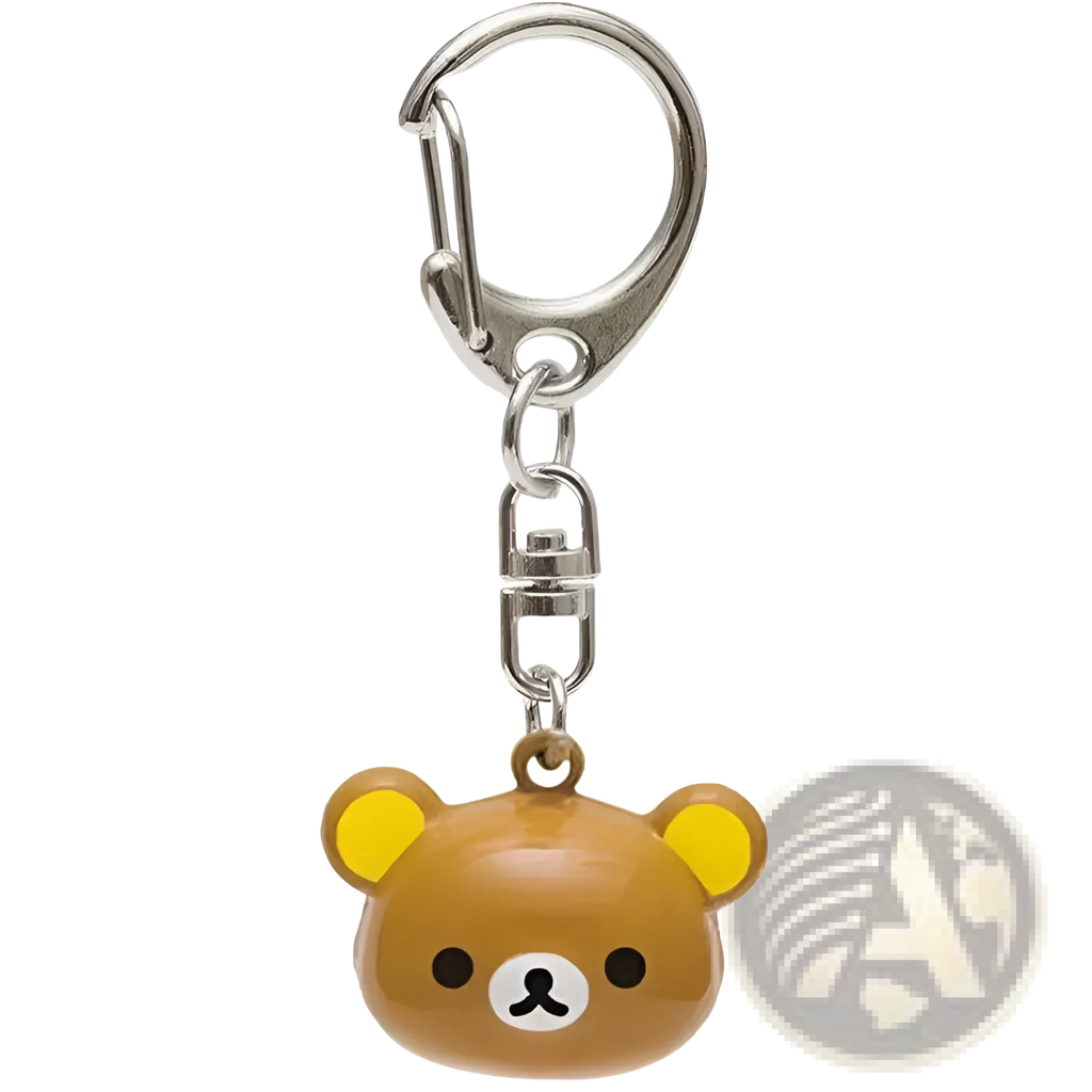 A brown rilakkuma bear keychain with yellow ears and white muzzle featuring glossy plastic enamel charm detailing