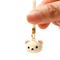 Cute cream-colored rilakkuma bear keychain charm with pink inner ears black eyes and gold-toned clasp in enamel set