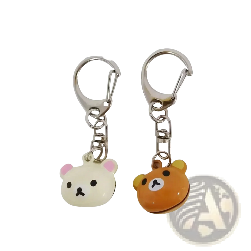 Two rilakkuma bear keychains in cream with pink ears and orange with yellow ears made of glossy enamel over metal