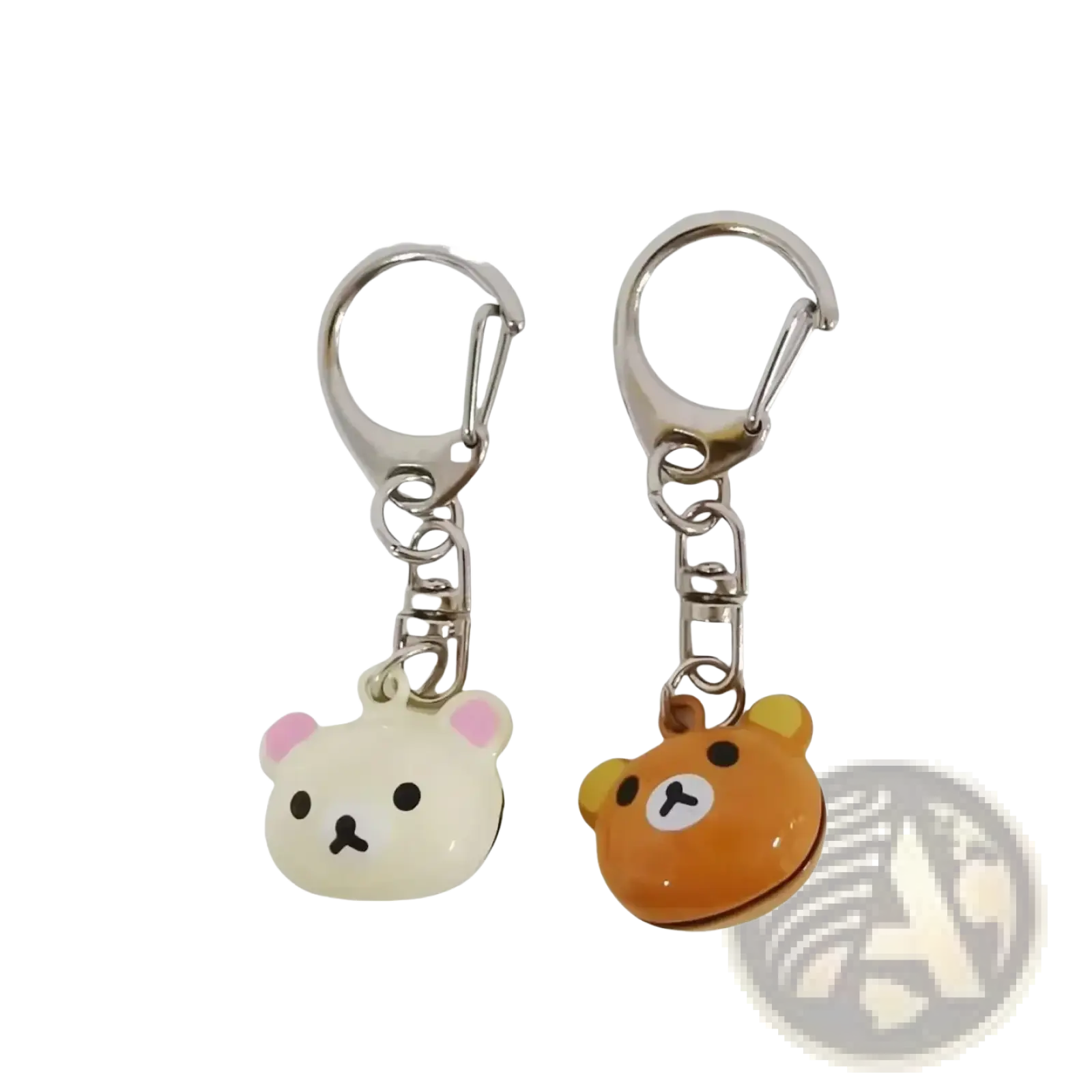 Two rilakkuma bear keychains in cream with pink ears and orange with yellow ears made of glossy enamel over metal