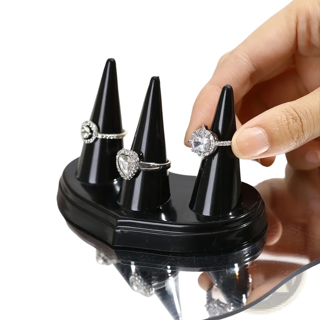 Black glossy plastic ring holder display stand with three conical holders for showcasing rings elegantly