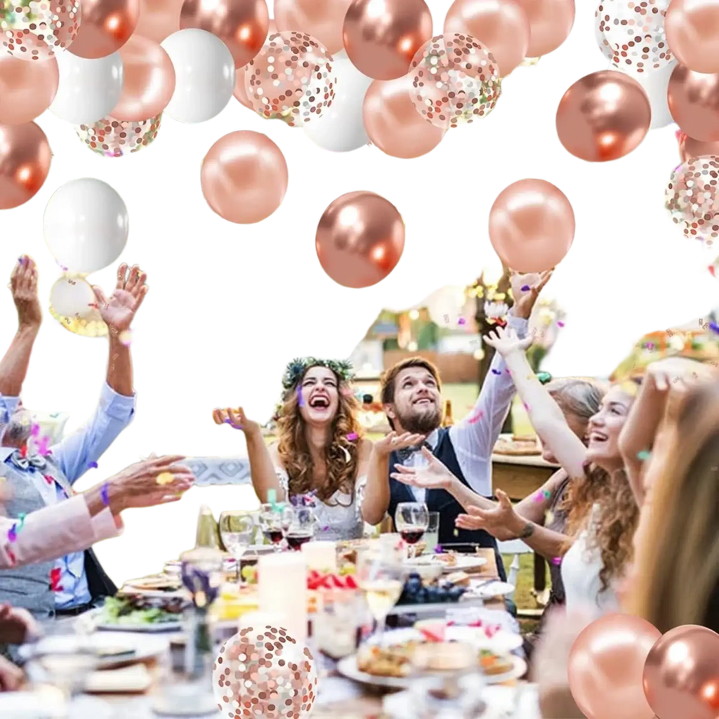 Rose gold and white metallic confetti balloons floating above an outdoor gathering for party decoration