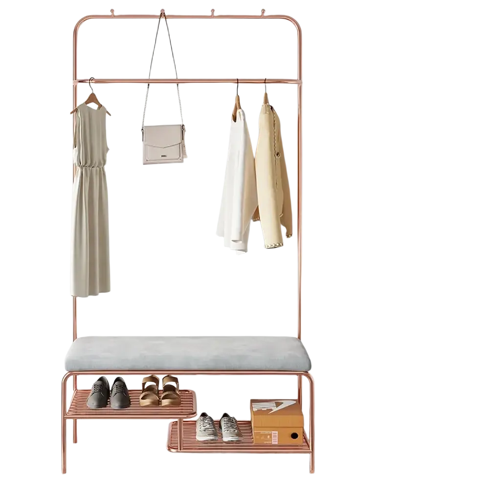 Rose gold metal kids clothes rack with a gray upholstered bench and two lower shelves for organized storage