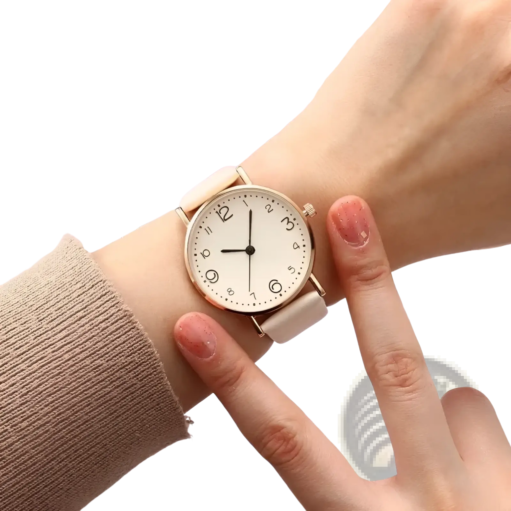 A rose gold leather casual watch with minimalist white dial and cream leather strap worn on a wrist with Arabic numerals