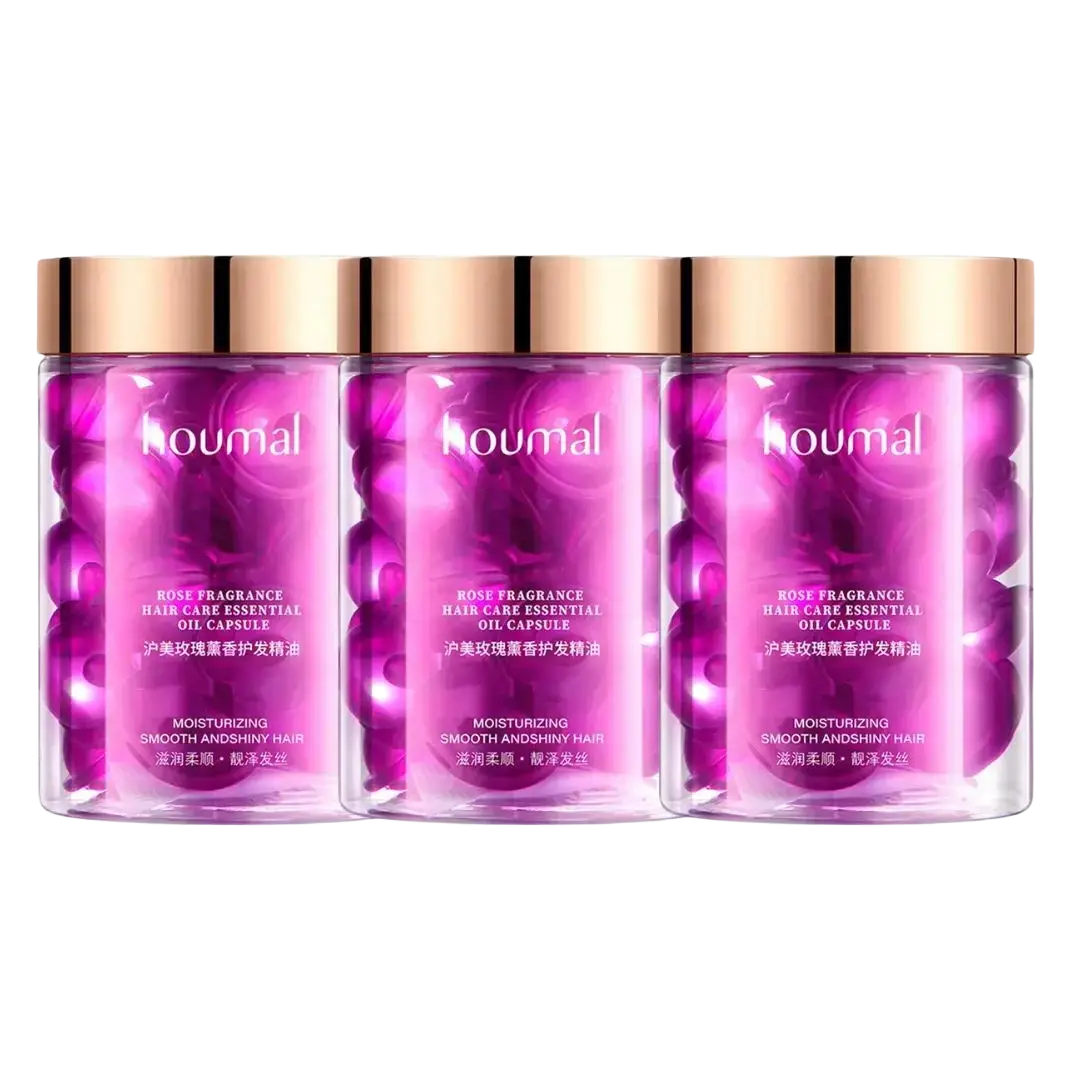 Three transparent bottles with rose gold caps containing pink koumal rose fragrance oil capsules for frizzy hair care