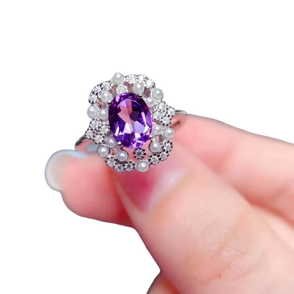 A sparkling silver ring with an oval-cut amethyst, diamonds, and pearl accents from rose quartz sterling silver jewelry set