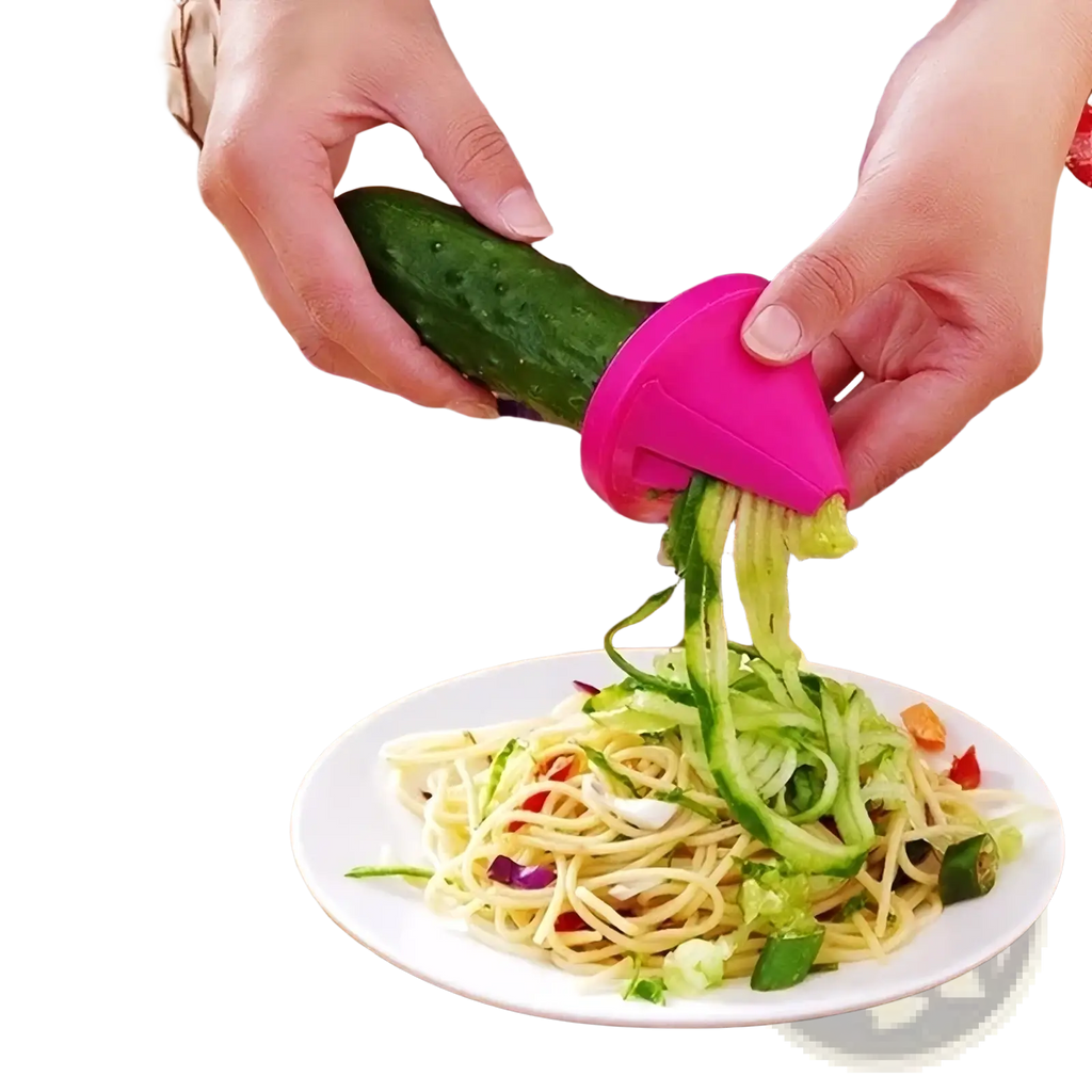 Pink plastic rotary vegetable grater and spiral slicer in use creating spiralized vegetables for cooking