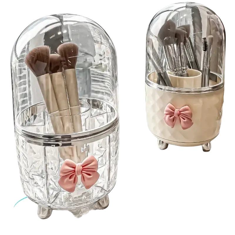 Rotating cosmetic makeup organizer with clear glass dome brush holder, pink bow, and silver feet for makeup storage