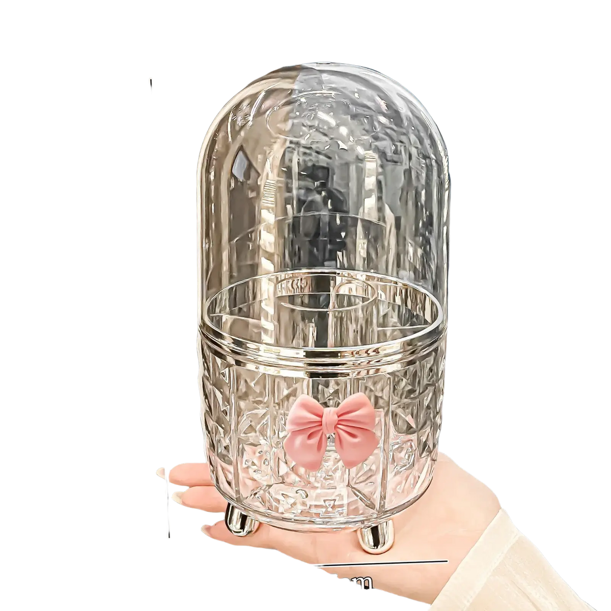 Clear glass hair accessory holder with silver base and pink bow on rotating cosmetic makeup organizer storage box