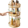 Gold three-tier rotating makeup organizer with large storage, clear glass shelves, ribbed edges, and metal rod design